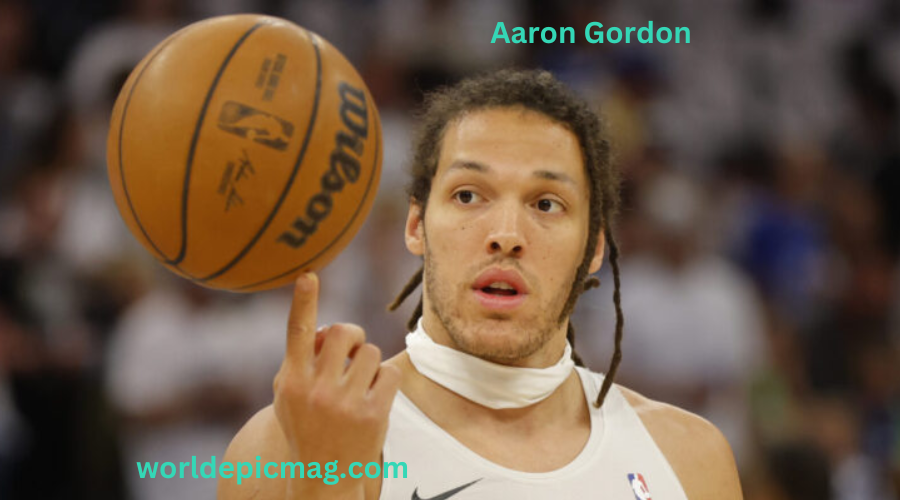 Aaron Gordon, Denver Nuggets NBA player, mid-air during an impressive dunk showcasing his athleticism and strength.